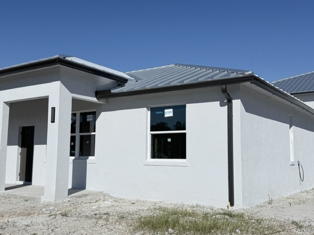 Black seamless gutter following a metal roofline