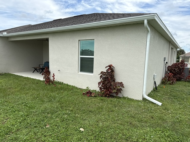White gutter following a cream home's roofline