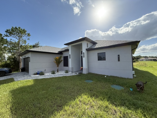 White home's front and roofline under a bright sky