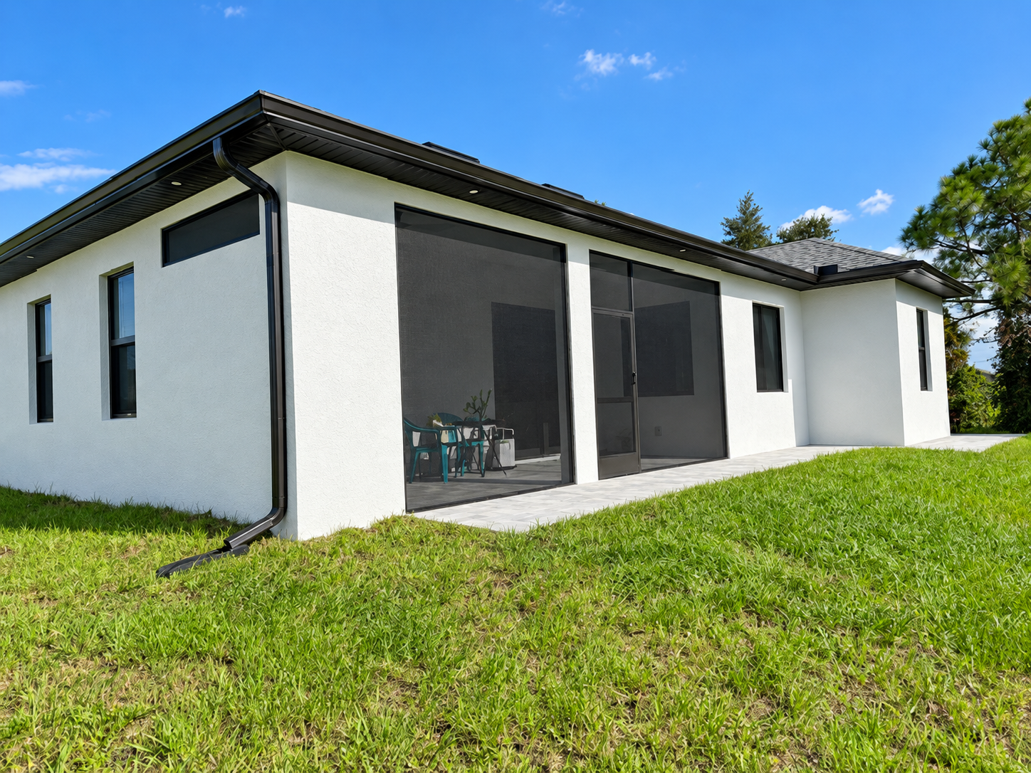 Screened patio on a white home with dark enclosure framing